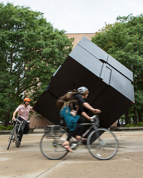 Bicyclists spin The Cube at Regents Plaza on Central Campus